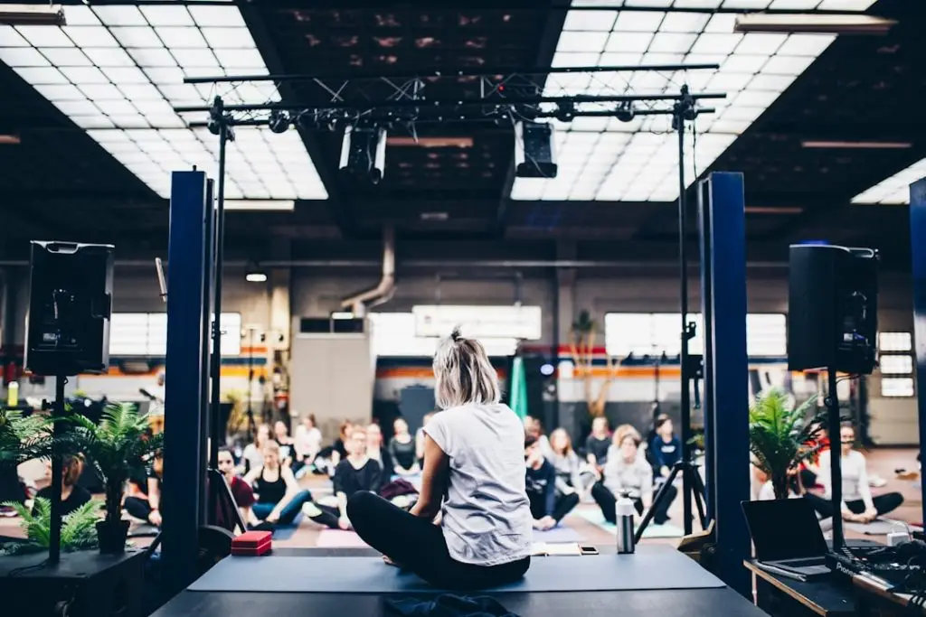 a woman sitting on a platform in front of a group of people