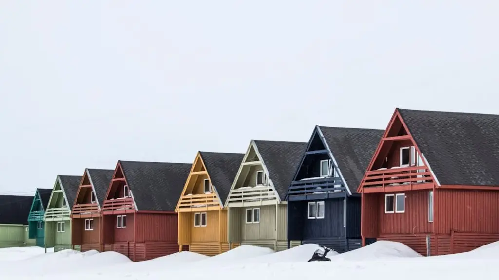 a row of colorful houses in the snow