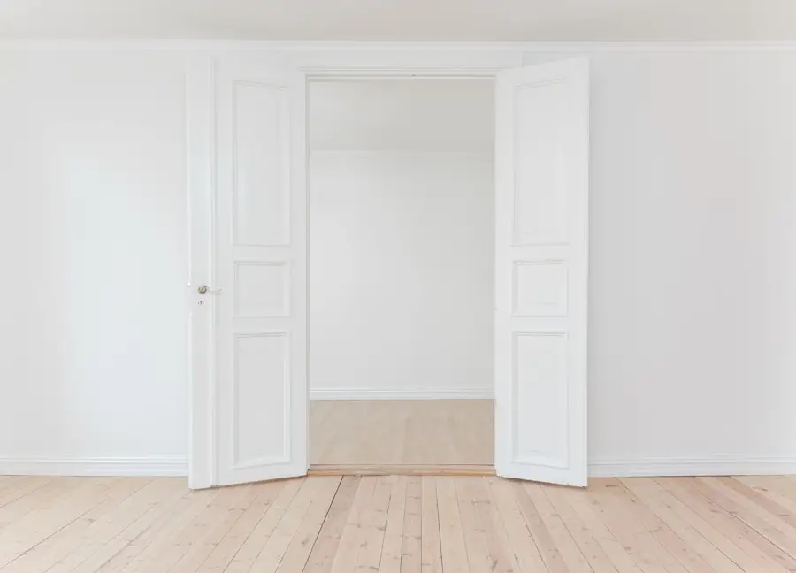 a white room with open doors