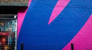 a blue and pink painted brick wall