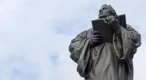 a statue of a man holding a book