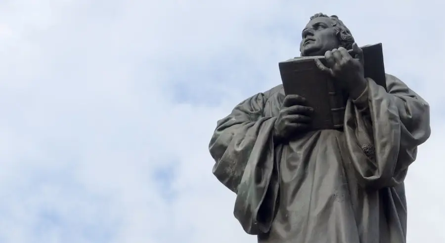 a statue of a man holding a book