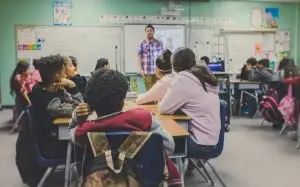 a man standing in front of a classroom